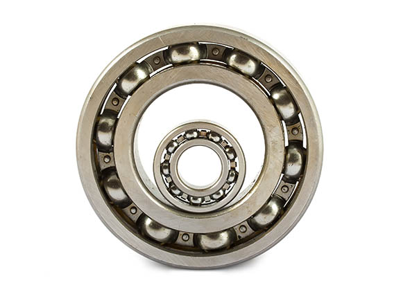 Big and small ball bearings on white background