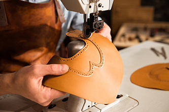 Close,Up,Of,A,Bootmaker,Working,With,Leather,Textile,On